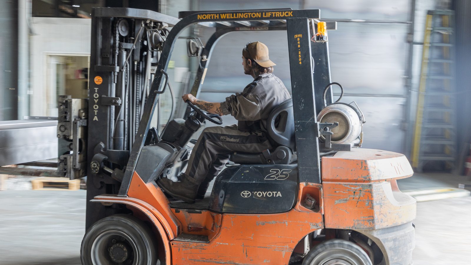Dynamic Millwrights Inc. worker driving forklift
